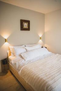 a bedroom with a bed with two lamps on it at Brand New Zippi`s- karmiel in Karmiel