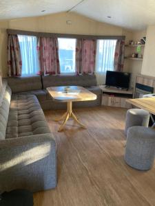 a living room with a couch and a table at Märchencamping in Stuhr