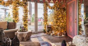 a living room with a large window with plants at Mariah Carey’s Ultimate Holiday Experience in New York City in New York