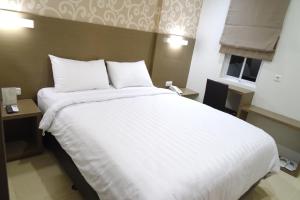 Postel nebo postele na pokoji v ubytování Yokotel Hotel