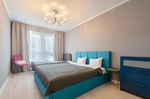 a bedroom with a blue bed and a chandelier at 13109 Cozy apartment nearby with Kiev Central Railway Station in Kyiv