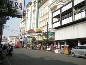 a busy city street with a group of buildings at Yokotel Hotel in Bandung