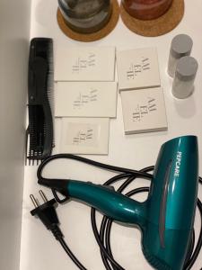 a white table with a green hair dryer and wires at Bed & Breakfast Donji Grad in Zagreb