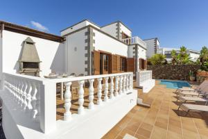 a villa with a balcony and a swimming pool at Villa Reymar in Tías