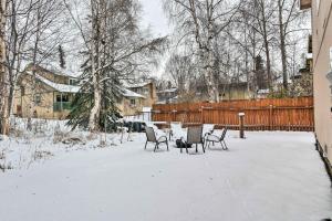 a table and chairs in a yard covered in snow at Charming Anchorage Townhouse with Fire Pit! in Anchorage