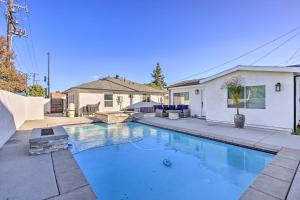 a swimming pool in the backyard of a house at Lovely Norwalk Retreat with Pool and Fire Pit! in Norwalk