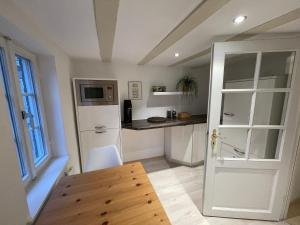 a kitchen with a white refrigerator and a table at Das Haus am Limburger Dom in Limburg an der Lahn