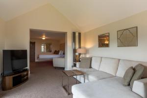 a living room with a couch and a tv at Lakes Hotel & Spa in Bowness-on-Windermere