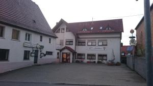 a large white building with a courtyard in front of it at Schozacher Stüble in Talheim