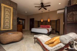 a bedroom with a bed and a couch in a room at Casa Harb Hotel Boutique in San Andrés