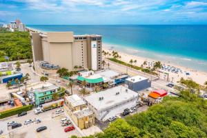 an aerial view of a beach and a building at The Purple Pelican Beachfront with Ocean Balcony Unit 1 in Fort Lauderdale