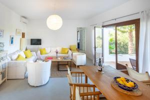 a living room with a couch and a table at Casa en Ibiza con vistas increíbles en Es Figueral in Es Figueral Beach