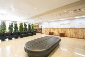 a salon with a waiting room with black leather seats at Urban Hotel Kyoto in Kyoto