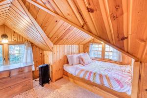 um quarto com uma cama num chalé de madeira em The Lucky Breaker em Rockaway Beach
