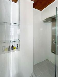 a shower with a glass door in a bathroom at IOANNIS STONEHOUSE, Quiet, Privacy & Sea View. in Kissamos