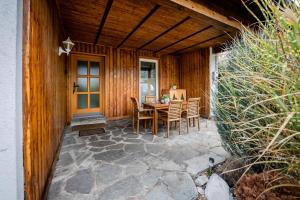 a patio with a table and chairs in front of a house at Haus Gerti in Zell am See