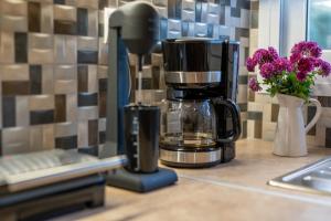 a coffee maker sitting on a kitchen counter with flowers at Villa Berlie in Keramiaí