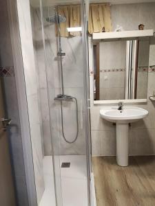 a bathroom with a shower and a sink at CarreraHouses OCouto in Pontevedra