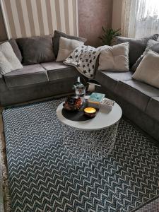 uma sala de estar com um sofá e uma mesa de centro em Lux apartman Lena em Belgrado
