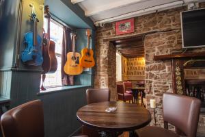 a dining room with guitars hanging on the wall at Horse and Hound Country Inn in Bonchester Bridge