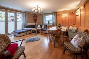 a living room with a table and chairs at Haus Gerti in Zell am See