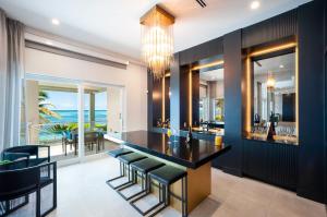 a kitchen with a black bar with a view of the ocean at Black Urchin Boutique Resort in Belford Estates