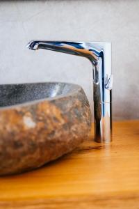 a bathroom sink with a rock next to a stone at Ferienhaus Visselheide in Visselhövede +45 photos