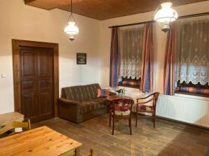 a living room with a couch and a table at U potoka Cedronu in Jilemnice