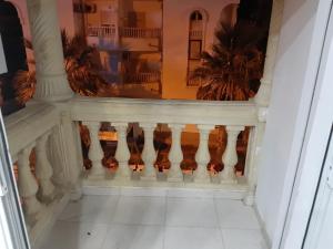 a stairway with a white rail and a balcony at Flat,App,Sea side,Stay Sousse 2-Bedroom in Sousse +1 photo