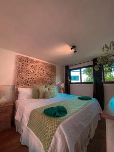 a bedroom with a large bed with a headboard at Hotel Maya Jade in Monterrico