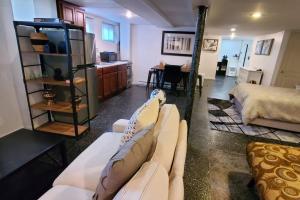 a living room with a couch and a bed at Cozy Studio; Lower Level Unit in Laurelton