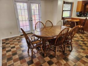 a dining room with a wooden table and chairs at Spacious 4-bedroom home in quiet neighborhood in Milwaukee