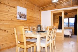 a dining room with a table and chairs at La Tanière : 4 personnes in Gérardmer