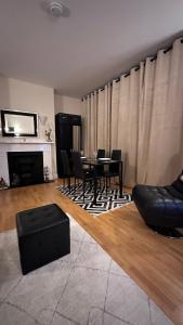 a living room with a black table and chairs at Central London spacious Studio in London