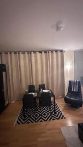 a room with a table and chairs and a curtain at Central London spacious Studio in London