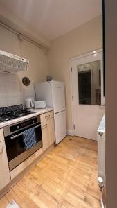 a kitchen with a stove and a refrigerator at Central London spacious Studio in London
