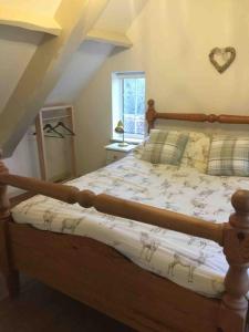 a bedroom with a bed with a wooden frame at Grove Farm Loft Annexe Includes Continental Breakfast in Lincoln