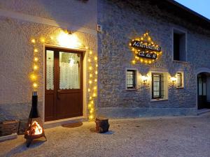 a building with christmas lights and a sign on it at Cà di N in Castel dʼAiano