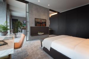 a bedroom with a large bed and a desk at The Mill Bomonti in Istanbul +54 photos