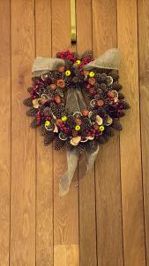 a wreath is hanging on a wooden wall at ROYAL WILLIAM YARD Luxury Apartments at "THE BRUCE" - FAMILY APARTMENT and Connecting DELUXE STUDIO - PRIVATE connecting lobby so BOOK BOTH For LARGER GROUPS - FREE ONSITE PARKING in Plymouth