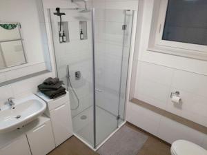 a white bathroom with a shower and a sink at Apartment mit Terrasse in Abstatt in Abstatt