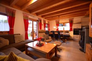 a living room with a couch and a table at Feriendorf Via Claudia Haus 82 Alpensee in Lechbruck