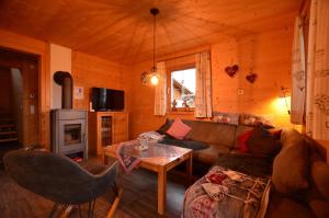 a living room with a couch and a table at Feriendorf Via Claudia Haus 74 Allgäuglück in Lechbruck