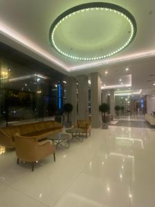 a lobby with a couch and chairs in a building at داماك برماونت in Riyadh
