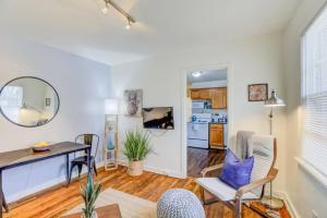 a living room with a desk and chairs and a kitchen at Midtown Cottage Walk to Overton Square in Memphis