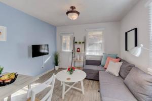 a living room with a couch and a table at Walk to the Best of Midtown Charming Cottage in Memphis