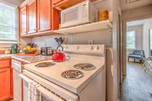a kitchen with a white stove and a microwave at Walk to the Best of Midtown Charming Cottage in Memphis