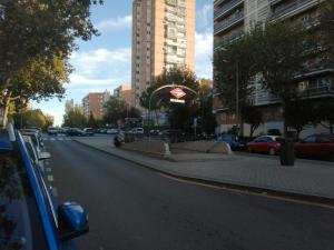 馬德里的住宿－HELLO HOME FERIA，一条城市街道,路边有汽车停放