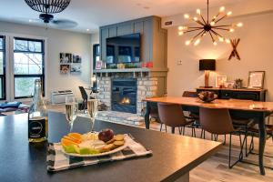 a kitchen and living room with a table with a plate of food at Rental condo Tremblant-les-Eaux in Mont-Tremblant