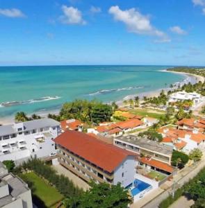 an aerial view of a city and the ocean at Praia dos carneiros flat hotel in Tamandaré